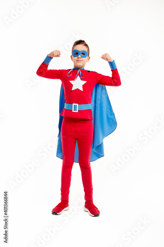 Strong little superhero showing muscles