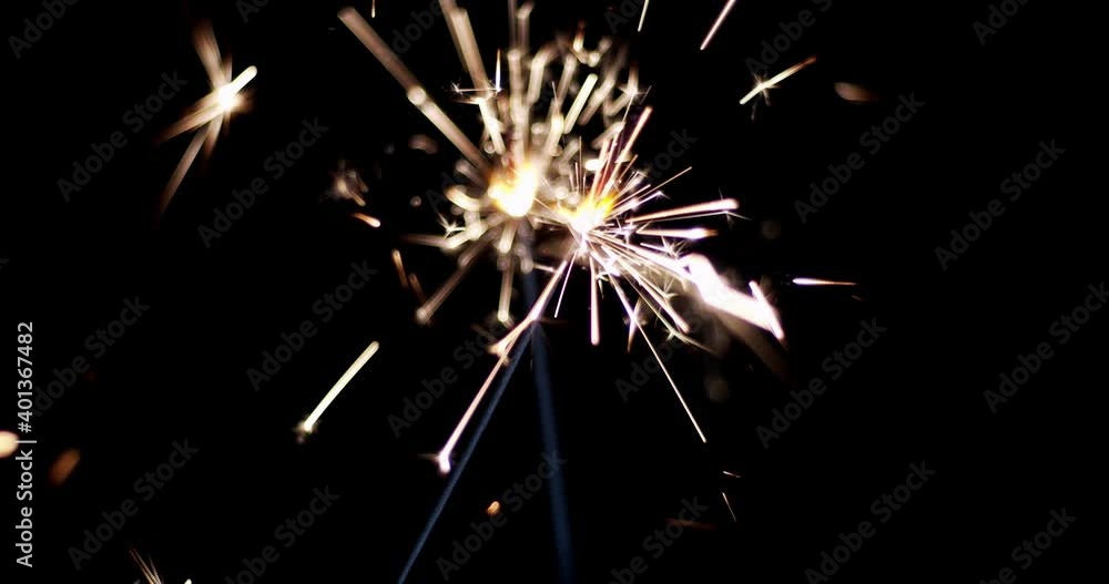 Lightening Christmas sparkler on the black background. Christmas sparkler concept. Bengal lights are burning on a black background. Holiday party concept. Christmas and newyear party sparkler. Lightening Christmas sparkler on the black background. Christmas sparkler concept. Bengal lights are burning on a black background. Holiday party concept. Christmas and newyear party sparkler.