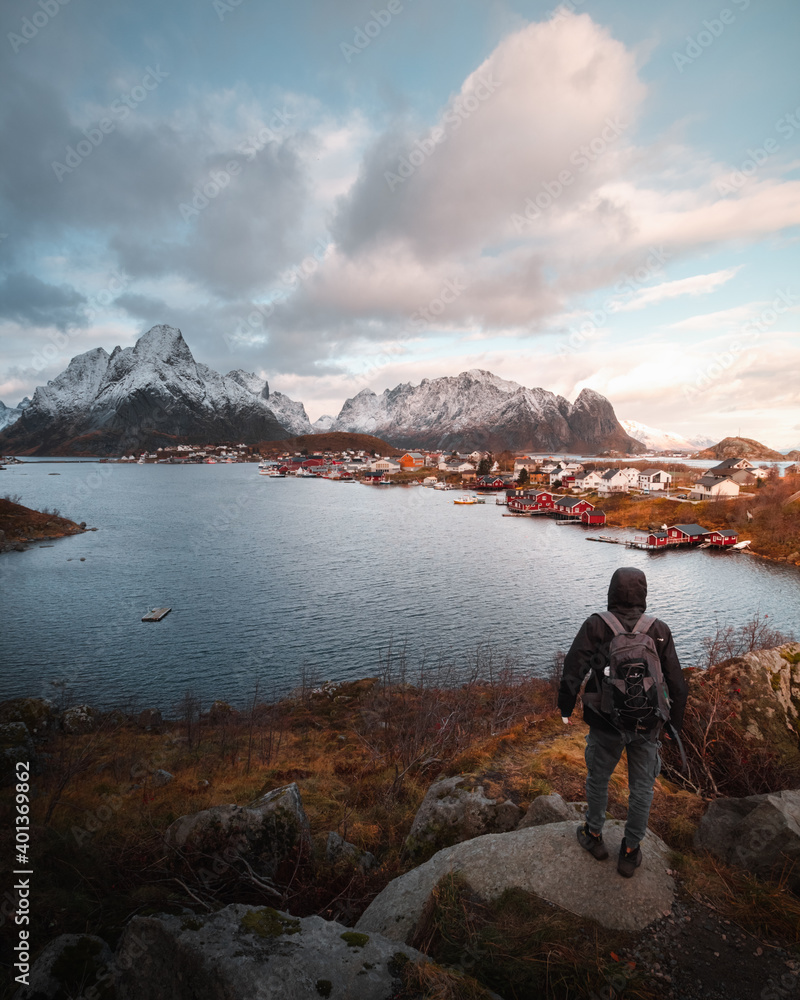 Traveler enjoying the view of Reine in Lofoten, Norway