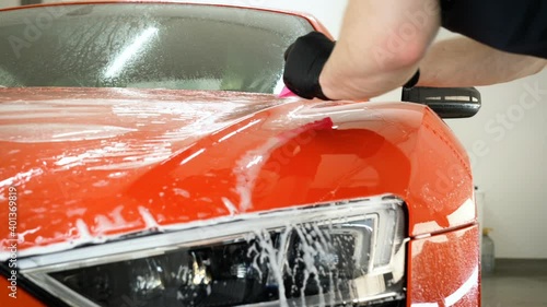 Close up to PPF installation process on a front rear headlight and bamper. PPF is a Paint Protection Film which protect paint