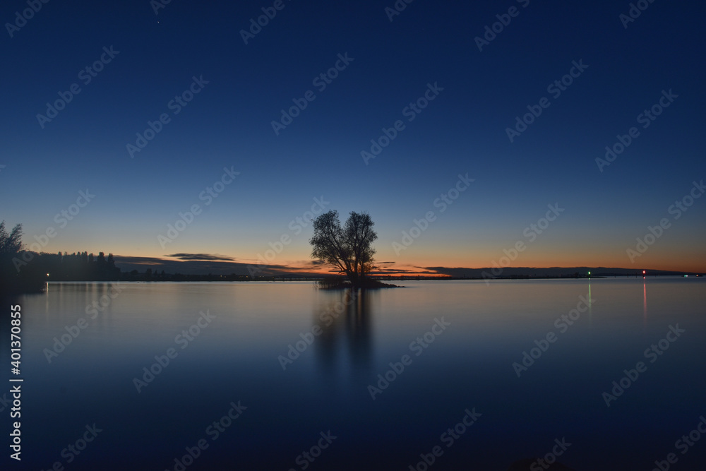 Small island with tree in last light of day