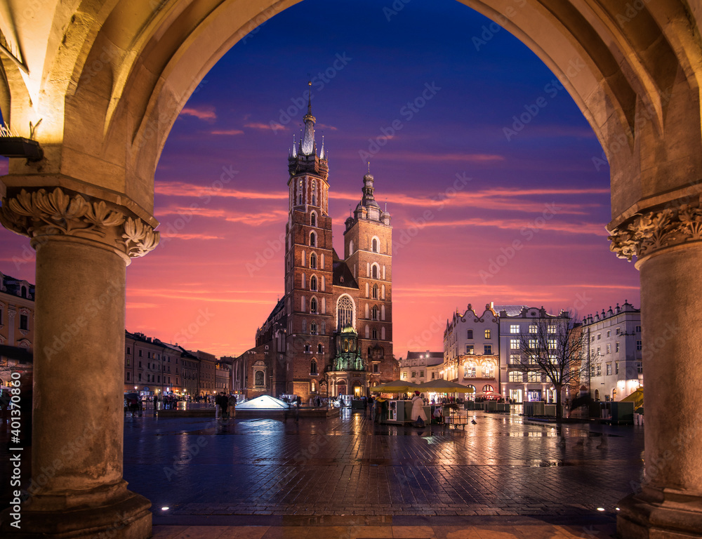 St Mary's Basilica (Mariacki Church) in the Old Town of Krakow (Cracow), Poland. Illuminated on The Main Market Square at night after sunset