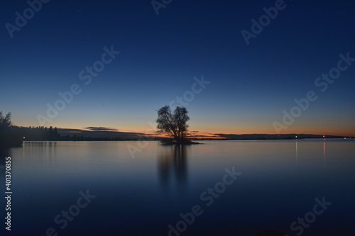 Small island with tree in last light of day