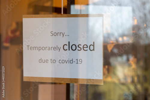 Closed sign at a frontdoor of a shop or restaurant due to covid 19 lockdown