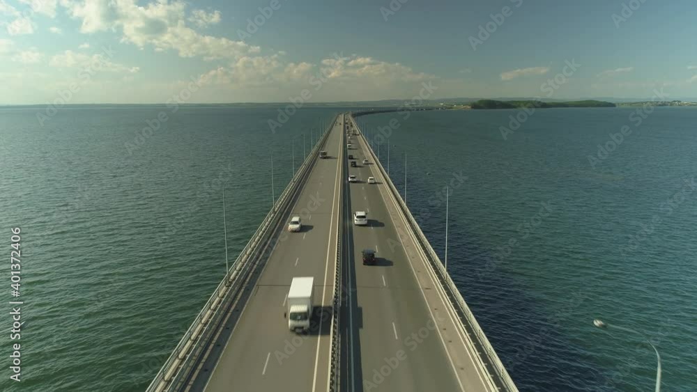 Drone forward epic flight low-water bridge over sea bay Vladivsotok Russia. Road traffic lot of cars ride. Modern best cityscape. Sunny sky, cumulus clouds horizon. Travel attraction. Quality footage Drone forward epic flight low-water bridge over sea bay Vladivsotok Russia. Road traffic lot of cars ride. Modern best cityscape. Sunny sky, cumulus clouds horizon. Travel attraction. Quality footage