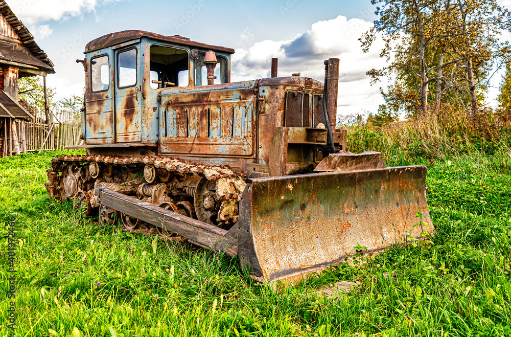 Old soviet arable rusty tractor