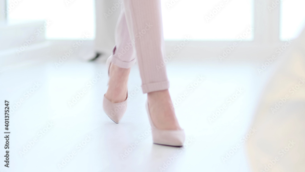 Fashionable woman wearing high heel shoes. Fashionable woman in high-heeled shoes. soft focus woman walking on white wooden floor. - obrazy, fototapety, plakaty 