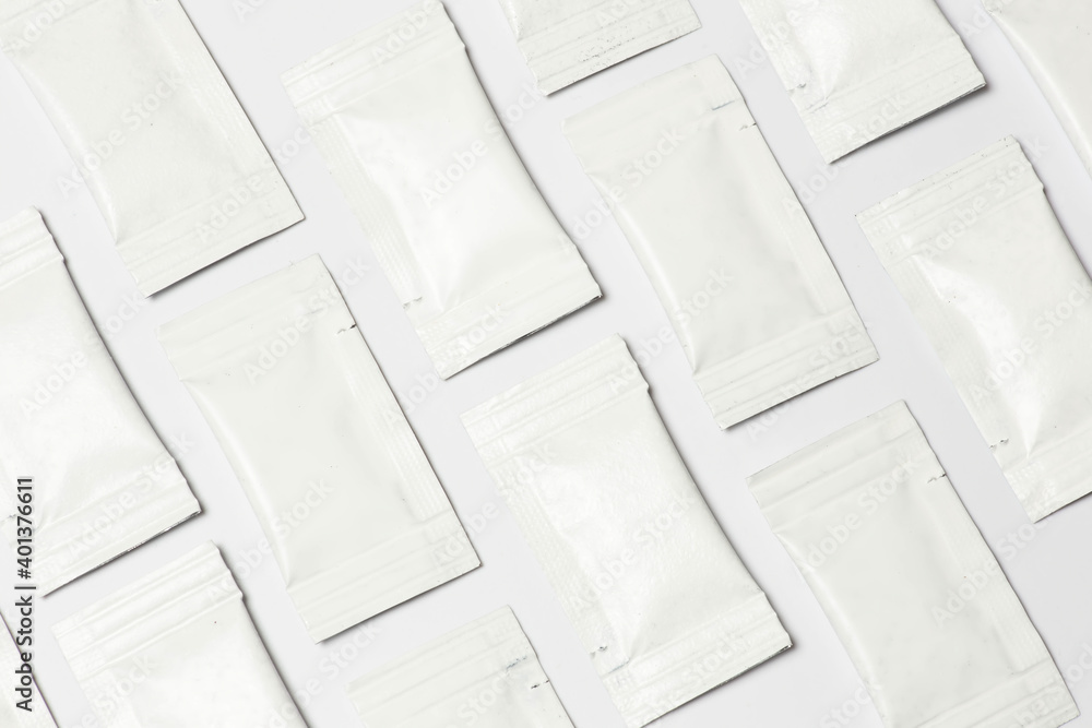Close-up composition of white sachets on a white background. Close-up composition of white sachets on a white background.