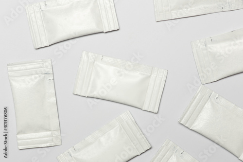 Close-up composition of white sachets on a white background.