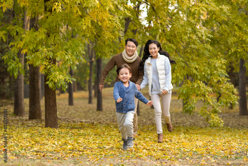 Happy young family running in woods Happy young family running in woods