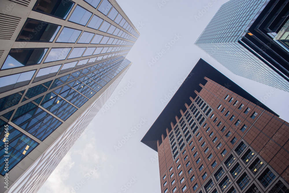 view from the bottom of the house modern business tall glass buildings with windows in the city center with sky