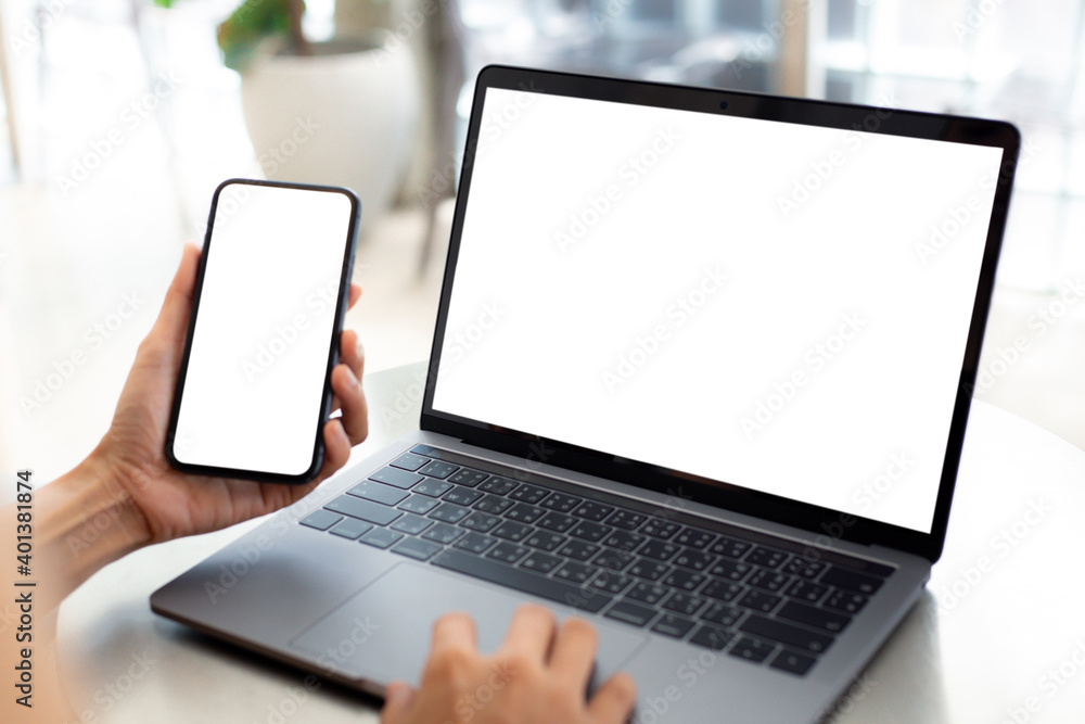computer screen,cell phone blank mockup.hand woman work using laptop texting mobile.with white background for advertising,contact business search information on desk in cafe.marketing,design computer screen,cell phone blank mockup.hand woman work using laptop texting mobile.with white background for advertising,contact business search information on desk in cafe.marketing,design