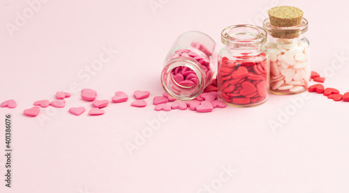 Sweets - hearts in small glass bottles. Colorful Valentines Day heart shaped candy with copy space. Sainte Valentine, mother's day greeting cards, invitation. © Nadya Vetrova