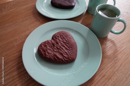 Composition of delicious tea in cups and gingerbread