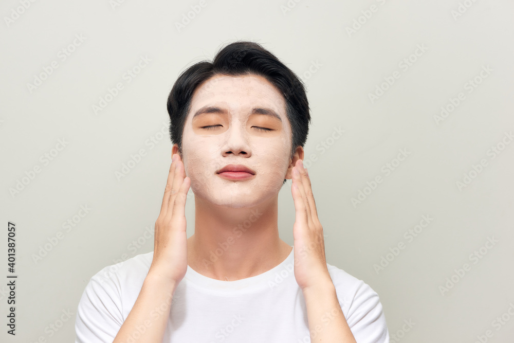 Male wearing clay face mask beauty treatment. Male wearing clay face mask beauty treatment.