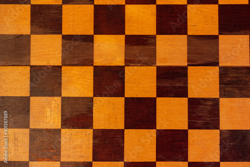 The surface of an old scratched checkerboard.