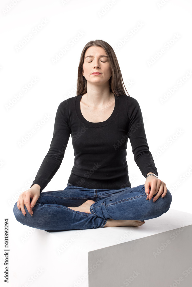 Beautiful brunette young woman meditating in the lotus position. Isolated vertical image on the white background. Beautiful brunette young woman meditating in the lotus position. Isolated vertical image on the white background.