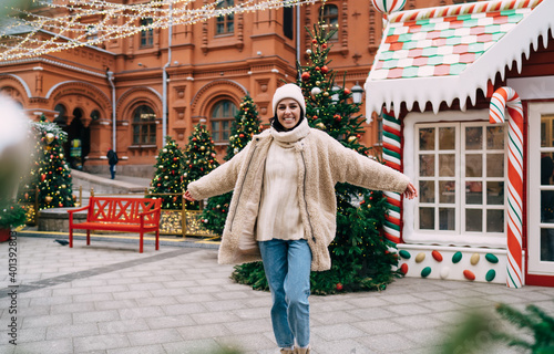 Delighted woman with outstretched arms at Christmas market © BullRun