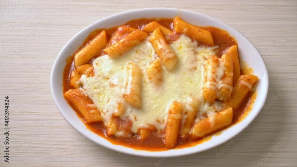 Korean rice cake in spicy Korean sauce with cheese, Cheese Tokpokki, Tteokbokki with Cheese - Korean food style Korean rice cake in spicy Korean sauce with cheese, Cheese Tokpokki, Tteokbokki with Cheese - Korean food style
