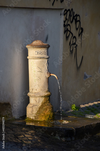 Drinking water fountain known as nasone (big nose) in Rome, Italy photo