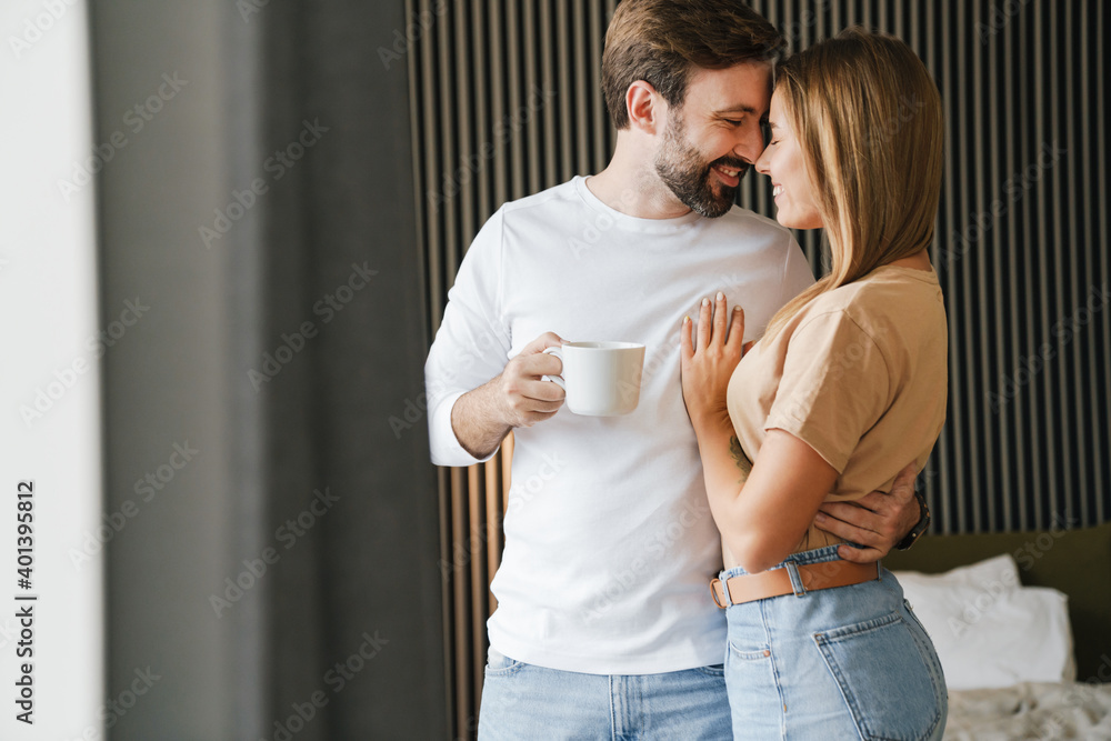 Happy young couple embracing while standing