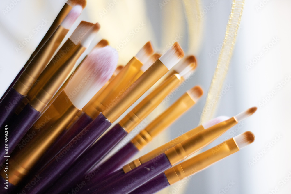Various make-up brushes together with a make-up removal tassel and makeup sponge.Cosmetic concept. Various make-up brushes together with a make-up removal tassel and makeup sponge.Cosmetic concept.