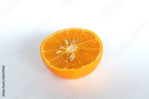 Closeup, Bright orange remaining orange cut in half on a white background. Copy space for design and text.