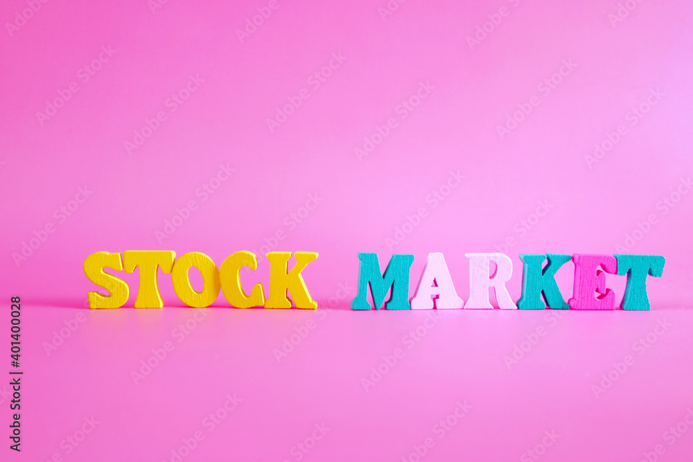 word stock market on pink background consists of colorful wooden letters in the abc alphabet block, which are the place for the ad text. The concept of learning English. word stock market on pink background consists of colorful wooden letters in the abc alphabet block, which are the place for the ad text. The concept of learning English.