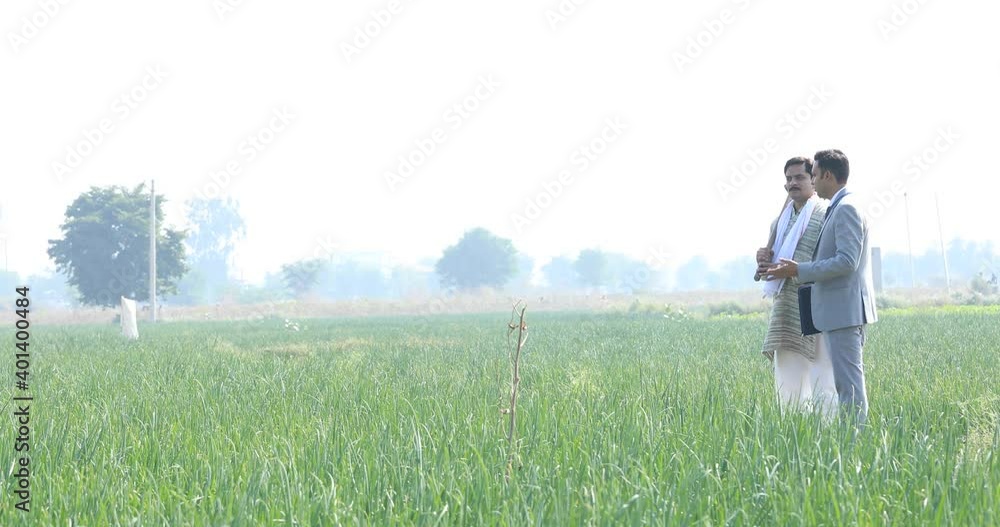 Businessman discussing with farmer on agriculture field Businessman discussing with farmer on agriculture field