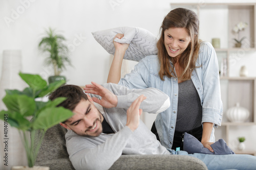 happy young couple sitting on the sofa having fun