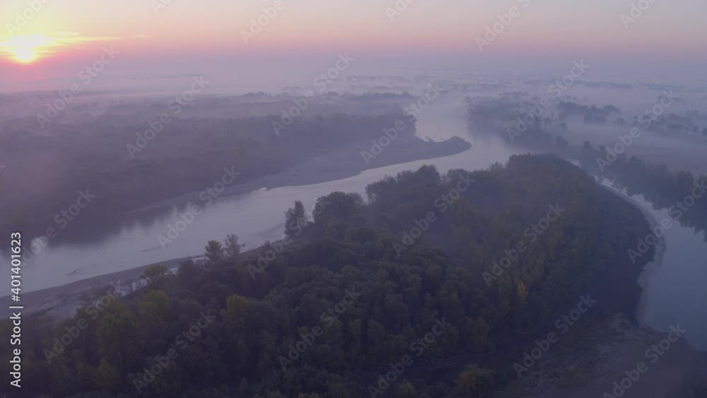 Aerial view of the morning mist and the rising sun on the natural Drava River with the bars and flood forests Aerial view of the morning mist and the rising sun on the natural Drava River with the bars and flood forests