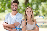 couple posing with badminton racket
