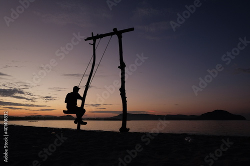 swinging on the beach © syaiful