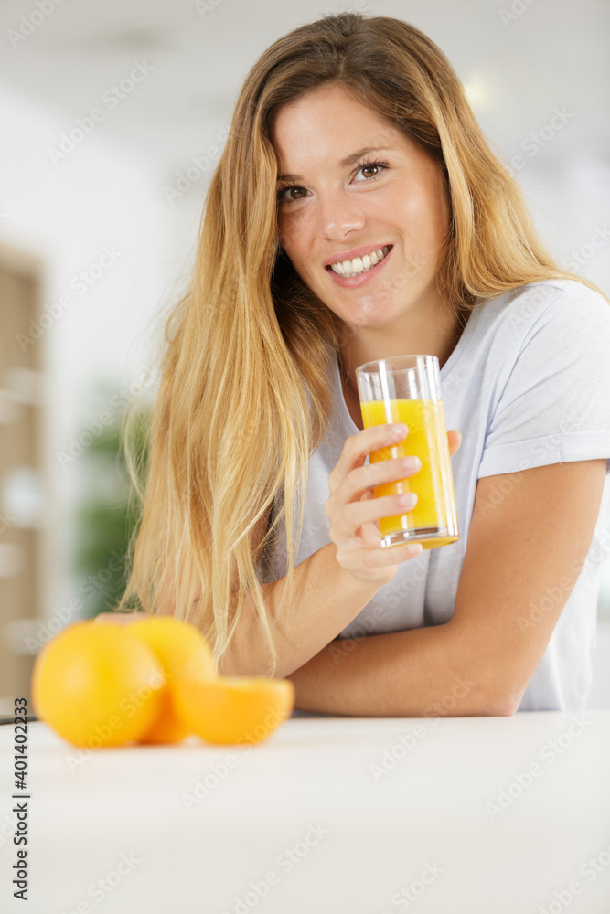 woman with glass of orange juice and fresh oranges woman with glass of orange juice and fresh oranges