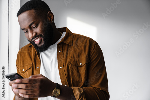 Attractive young african man using mobile phone
