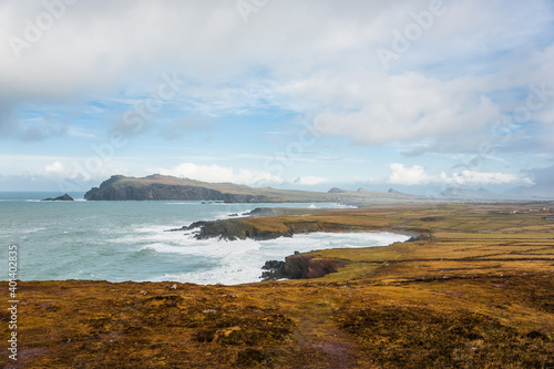 Scenic landscape with atlantic ocean shore, many mountains tops, hills and picturesque irish village during winter autumn season in Ireland. Concepts: season, outdoors, travel, landscape