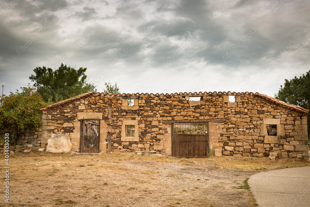 ruins of an old rustic house made of stones on an overcast day