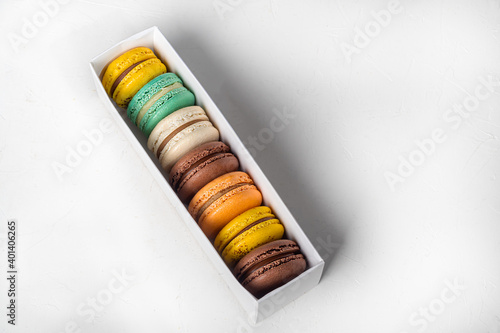 Round multicolored macaroon cakes on a light background. Home delivery. Festive concept. Quarantine. © Оксана Клименко
