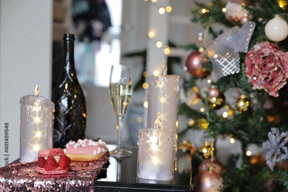 Three candles with stars, bottle of wine with glass of champagne, Christmas tree, xmas time decoration Three candles with stars, bottle of wine with glass of champagne, Christmas tree, xmas time decoration