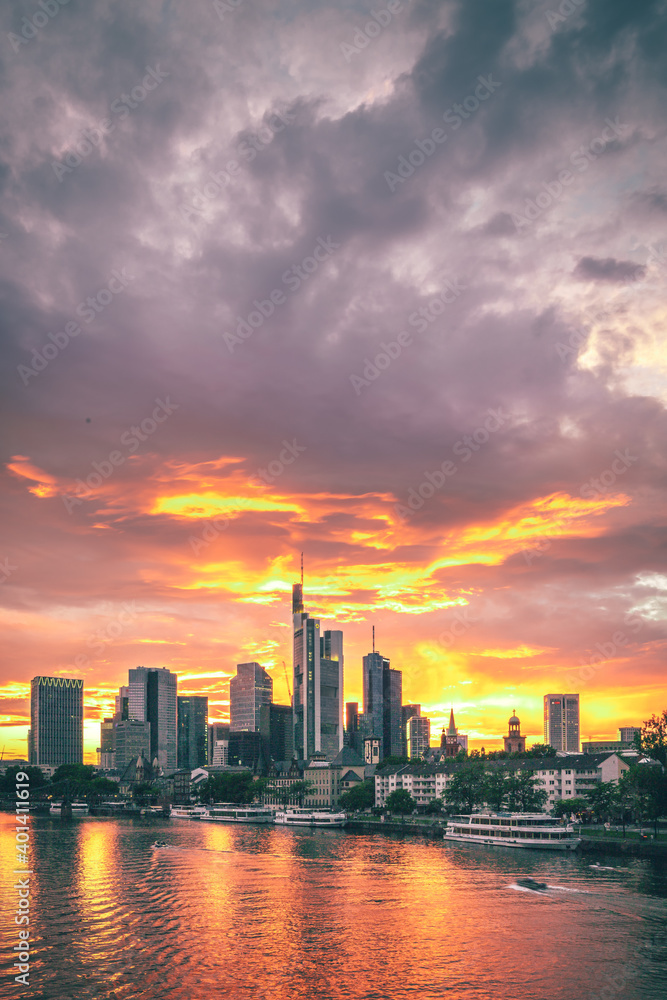 What a mood in the sky, sunset with incredible clouds and colors with a view over the Main. The Frankfurt skyline can be seen in the background. Shipping romance on the river in Germany