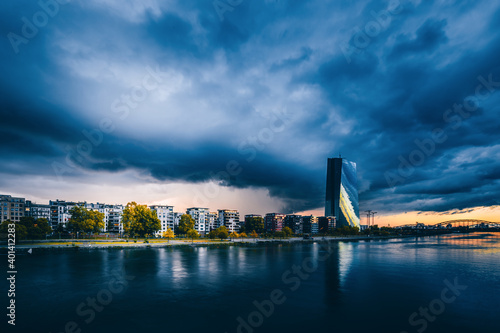 Thunderstorms and storms with weather phenomena over Frankfurt. Clouds over the skyline and the Main. Dramatic mood with skyline. Boot auf dem Fluss. 