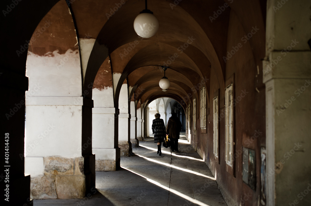 Archway in the city of Prage with the sunligth coming along the columns