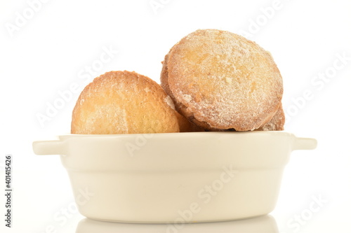Several delicious biscotti shortbread cookies with white ceramic crockery, close-up, isolated on white.