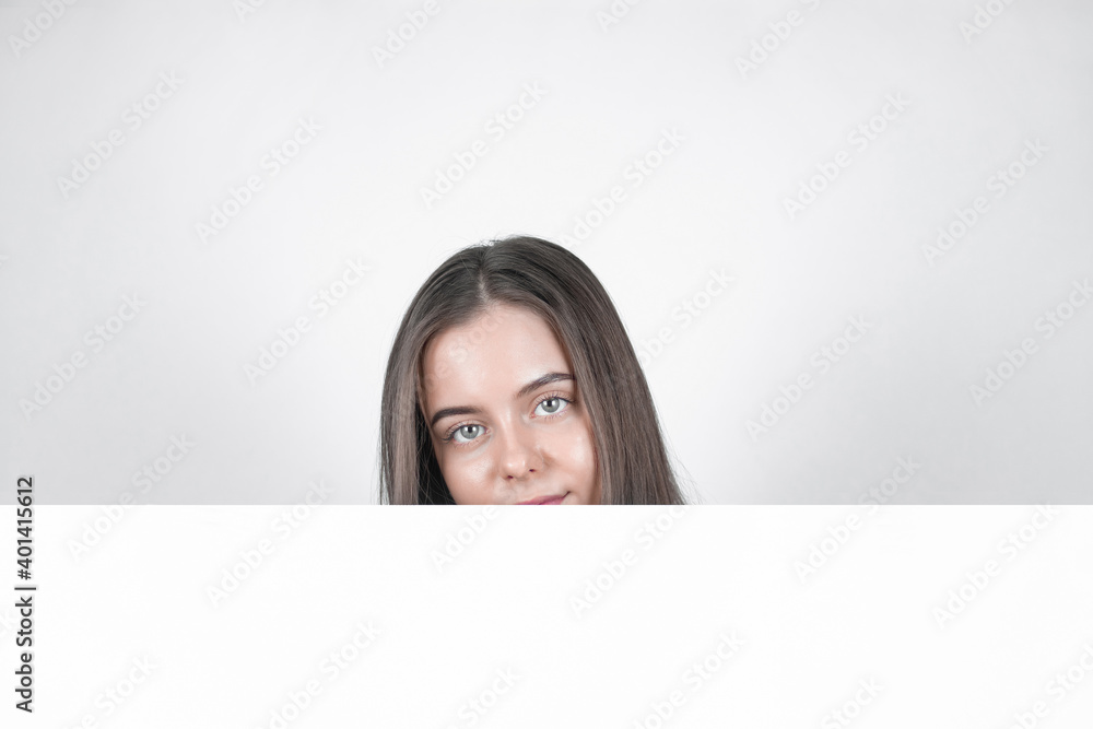 Woman сhiding behind blank copy space banner Woman сhiding behind blank copy space banner
