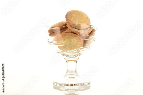 Shortbread biscotti in a glass dish, close-up, on a white background