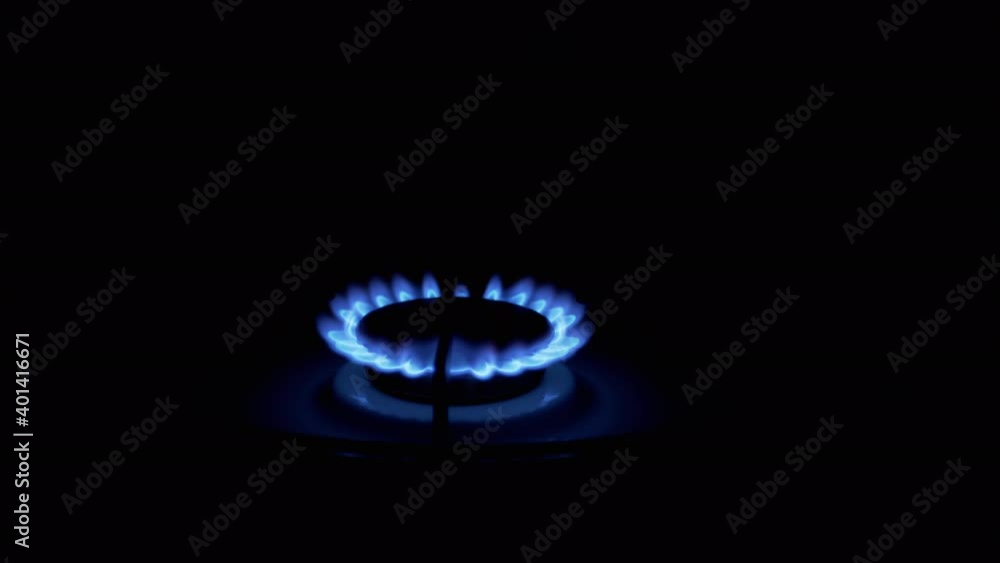 Gas Burner On, Glowing with Blue Flame, at Night in Kitchen. Close-up Gas Burner On, Glowing with Blue Flame, at Night in Kitchen. Close-up