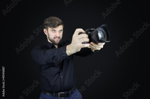 male photographer looks at digital camera display