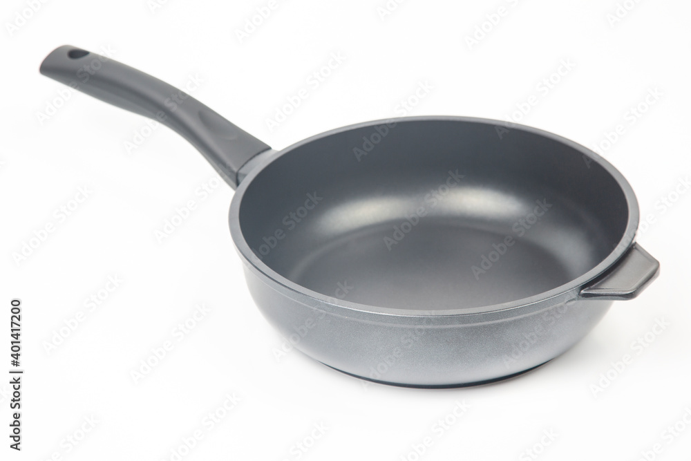 Black frying pan with non-stick teflon coating on white background Black frying pan with non-stick teflon coating on white background
