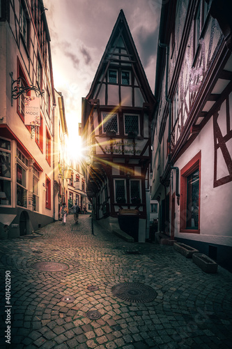  Half-timbered house from Germany located in a street. Cloudy in the evening and illuminated