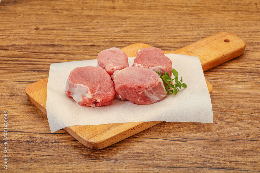 Raw pork medallion served rosemary